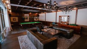 a living room with couches and a pool table at ALDONZA CHALET Akkol in Akkol'