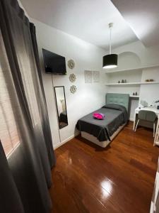 a bedroom with a bed and a desk in a room at Habitaciones Magdalena in Madrid