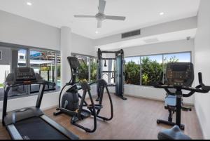 a gym with treadmills and ellipticals in a room at The Beach Oasis ~ Dune in Kingscliff