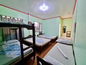 a group of bunk beds in a room at Oasis Resthouse in San Agustin