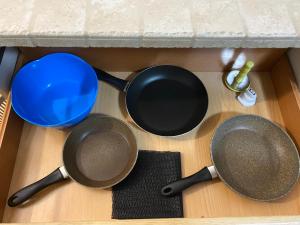 a group of pots and pans on a kitchen floor at Appartamento I Castagneti in Pasturo