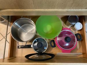 a shelf with pots and pans and a fan at Appartamento I Castagneti in Pasturo