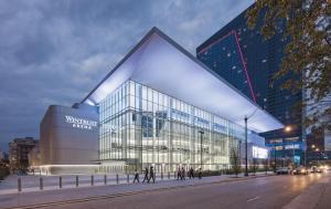 a large glass building with people walking in front of it at McCormick Place 3br-2ba luxury Family Heaven with optional parking for 8 guests in Chicago