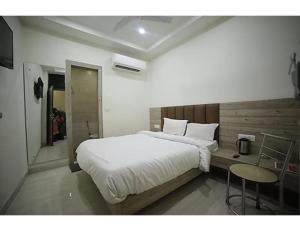 a bedroom with a large bed and a table at HOTEL SHRI RAM RESIDENCY, Agra in Agra