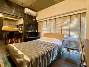 a bedroom with a bed and a table and chairs at Tokyo Shibuya+2rooms+45m2+4pplmax+Best location+well designed in Tokyo