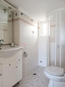 a bathroom with a toilet and a sink and a shower at Socrates in Elafonisos