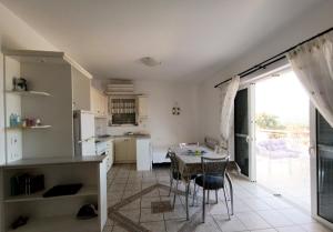 a kitchen with a table and chairs in a room at Socrates in Elafonisos