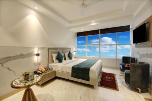 a bedroom with a bed and a large window at Hotel Transit International- Aerocity Delhi Airport in New Delhi