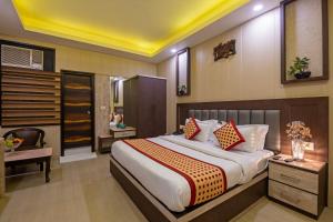 - une chambre avec un grand lit et un bureau dans l'établissement Hotel Mahajan International, Delhi Airport, à New Delhi