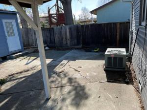 a backyard with a fence and a heater on the ground at 40223 Fremont Entire Coze 3brs house Free Parking nd AC in Fremont