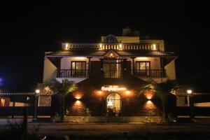 a large house with lights on it at night at Ponni Homestay Kumbakonam in Kumbakonam