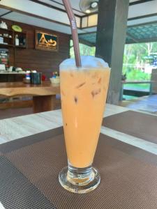 a drink in a glass with a straw on a table at kohkoodfarmstay in Ban Ao Yai