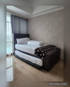 a bedroom with a bed and a window at Menteng Park - Tower Diamond, 2 Bed Rooms, Private Lift in Jakarta
