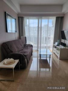 a living room with a couch and a table at Menteng Park - Tower Diamond, 2 Bed Rooms, Private Lift in Jakarta +10 photos