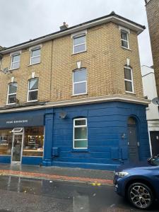 a blue building on the side of a street at Crystal Palace 2 Bedroom Flat in Crystal Palace