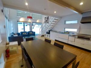 a kitchen and living room with a table and chairs at Hirafu House 7 in Ōmagari