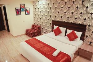 a hotel room with a bed and a chair at Hotel Global Stay Near Delhi Airport in New Delhi