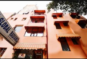 a tall building with windows and a street sign at Hotel Global Stay Near Delhi Airport in New Delhi