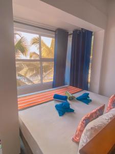 a bedroom with a bed with a window at Indika Beach Villa in Galle