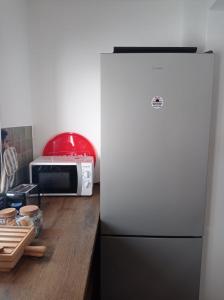 a kitchen with a refrigerator and a microwave at Las 3 Puertas 1 in Vejer de la Frontera +42 photos