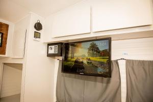 telewizor z płaskim ekranem wiszący na ścianie w obiekcie Motorhomes na Serra w mieście Teresópolis