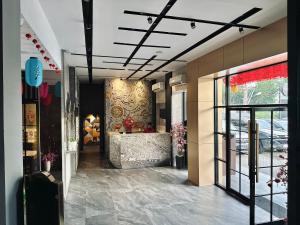 a hallway of a building with a lobby with a door at My Home Hotel Pontianak in Pontianak
