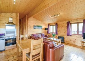 a living room with a couch and a table at Trewythen Lodges in Caersws