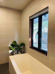 暹粒的住宿－Roya Khmer House，浴室设有窗户和盆栽植物