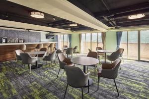a conference room with tables and chairs and windows at Beach Resort Green Bay in Wanli