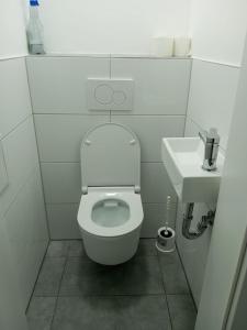 a small bathroom with a toilet and a sink at Nina Zimmer in Heilbronn Zentrum in Heilbronn