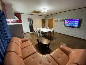 a living room with a couch and a table and a tv at Kashibesso Kiteki - Vacation STAY 26650v in Kitakyushu