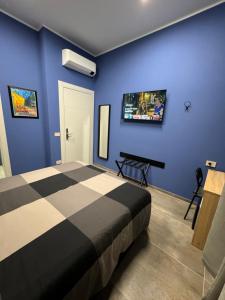 um quarto com uma cama e uma televisão na parede em B&B Parma Centro em Parma