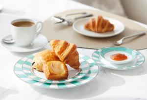 a table with two plates of pastries and a cup of coffee at Regent Shanghai on the Bund in Shanghai