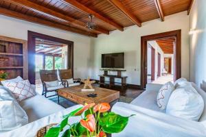 a living room with a couch and a table at Beautiful and Comfortable Four Bedroom Villa in Cajuiles