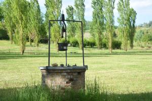 a bird feeder on top of a brick wall in a field at Relais Cascina San Martino in San Marzano Oliveto