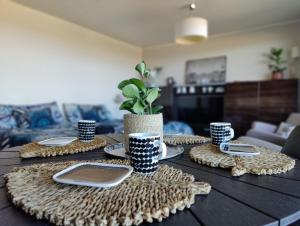 a table with plates and cups on top of it at Timantti Apartments by Hiekka Booking in Kalajoki
