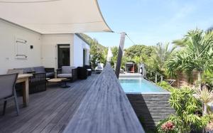 a deck with a swimming pool and a house at Luxury Vacation Villa 14 in Anse des Cayes