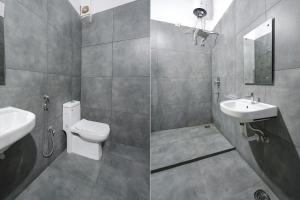 a bathroom with a sink and a toilet and a mirror at FabHotel Skycity in Haidar Sāhibgūda