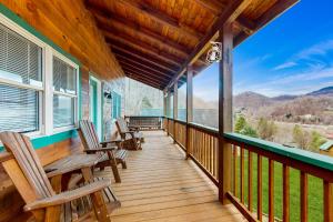 a porch with chairs and a view of the mountains at Up on Tanner Trail in Waynesville