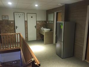 a kitchen with a refrigerator and a sink and a bathroom at Ubytovna Statek Olomouc in Olomouc +43 photos