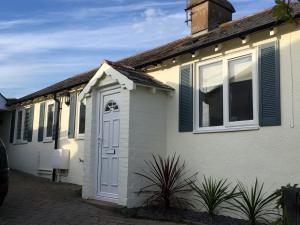 a white house with a white door and windows at 1 Bed in Instow 52974 in Instow