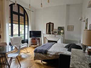 a bedroom with a bed and a fireplace at L'ile Des Prevots in Crosne