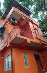 ein orangefarbenes Gebäude mit Balkon in der Unterkunft ANDAMAN EXQUISITE in Port Blair