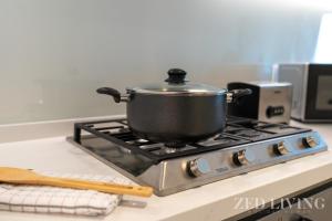 a pot on top of a stove in a kitchen at Zed Living - Ahad Residences - Tranquil 1 BR in Business Bay in Dubai
