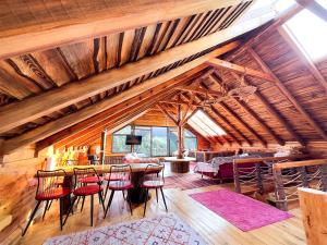 sala de estar con techos de madera, mesa y sillas en Aynştayn Chalet, en İznik