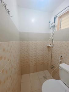a bathroom with a shower and a toilet at Transient House Orani in Orani