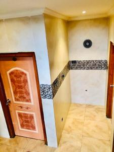 an empty room with a door and a tile floor at HOTEL TEJASRI RESIDENCY in Vijayawāda