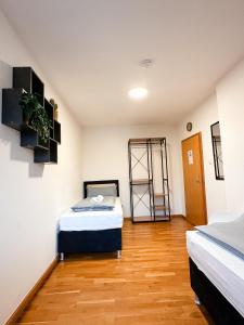 Cette chambre dispose de deux lits et de parquet. dans l'établissement Salí Homes Casablanca Cozy Apartment with Parking and Laundry Room Perfect for Your Getaway, à Bayreuth