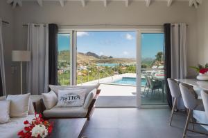 a living room with a view of a pool at Luxury Vacation Villa 15 in Saint Barthelemy