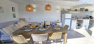 a kitchen with a table with plates of food on it at Jacuzzi, summer kitchen, gardens, 20m to beach - Villa Casa Plaza in Seget Vranjica